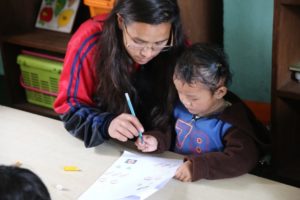 HCC Nepal Orchid Garden Girl Writing HCC Nepal Orchid Garden Girl Writing